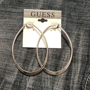 NWT Guess silver long oval hoop earrings. Never worn.